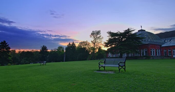Dramatic clouds time lapse with the sun peeking from behind, on a clear summer day in Avery Hill park, London, UK