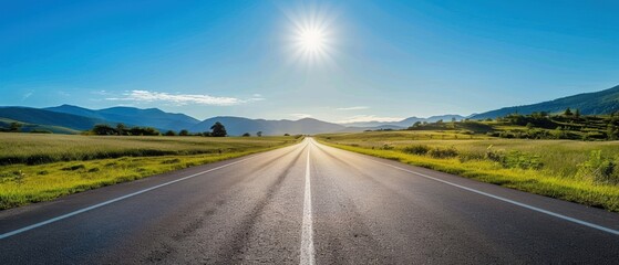 Scenic road under a clear blue sky, leading to the horizon, symbolizing travel and adventure