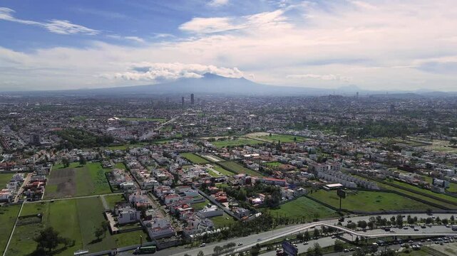 Aerial view of the city of Puebla with the Malinche volcano in the background during the summer