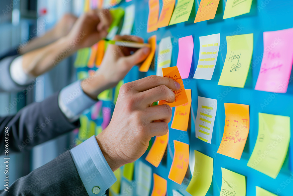 Poster person is writing on a table with colorful sticky notes. the table is covered with various colored s