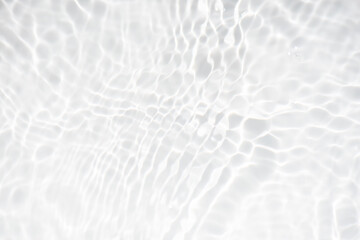 White water with ripples on the surface. Defocus blurred transparent white colored clear calm water surface texture with splashes and bubbles. Water waves with shining pattern texture background.