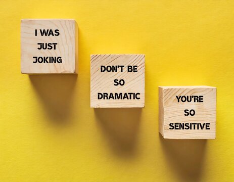 Wood blocks on yellow background with text written I WAS JUST JOKING, DON'T BE SO DRAMATIC - YOU'RE SO SENSITIVE, gaslighting verbal abuse use to manipulate and pin whole blame to victim