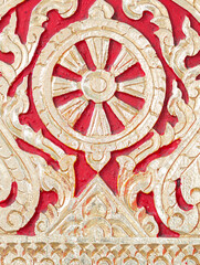 Dhammachak symbols in Buddhism are carved on wood painted in shiny gold.