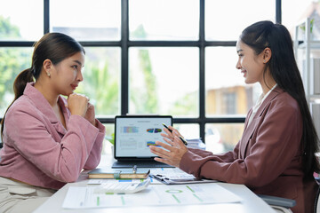 Asian female sales representatives in the section of Real estate talked and discussed tax plans to...