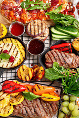 Grilletables and meat. Cooked steak, corn, pepper, peach on light background. Food concept