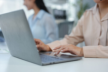 Asian freelance businesswoman with headset and microphone working on laptop talking with clients and colleagues about business information via video call. online communication concept