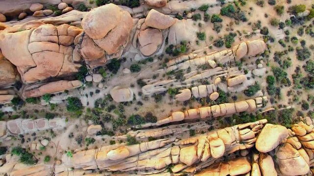 Aerial: Drone Top Backward Full Frame Of Stark Desert Landscape During Sunset - Joshua Tree, California
