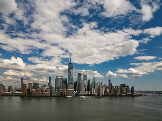 Naklejka premium NYC aerial view, New York City Skyline with dramatic sky. Panoramic drone view on Manhattan in NY.