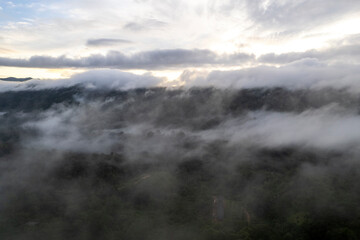 Landscape of Morning Mist with Mountain Layer at north of Thailand. mountain ridge and clouds in rural jungle bush fores