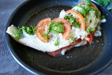 Fish fillet with tomatoes and dill. Preparation of fish for baking.