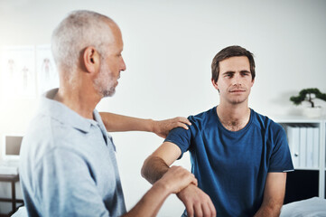 Obraz premium Men, physiotherapy and patient for rehabilitation with stretching arm for support, healing and healthcare. People, injury and clinic with fitness, exercise and workout for wellness and wellbeing