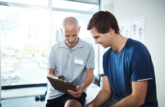 Men, physiotherapist and happy with patient for rehabilitation with clipboard in smile for checklist, results and report. People, and healthcare clinic on fitness, exercise and training for wellness - Powered by Adobe