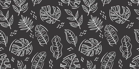 Palm leaves on a black background. Vector pattern of exotic palm leaves.