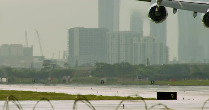 Four-Engine Airplane Landing at Miami Airport in Slow Motion