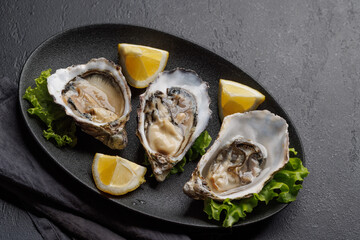 Fresh oysters with lemon on plate