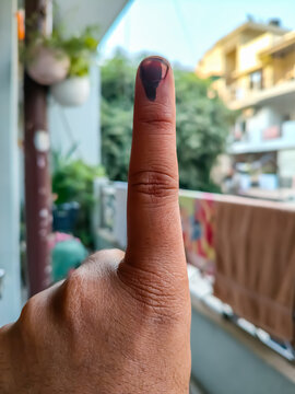 Young voter showing her ink-marked fingers after casting votes near polling booth of east Delhi, India for general Lok Sabha Elections 2024