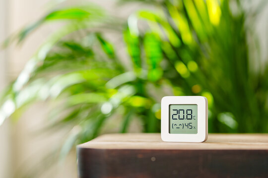White Digital Thermometer Displaying Temperature and Humidity