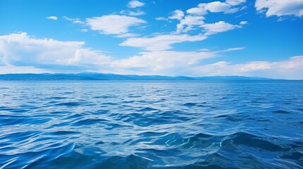 Obraz premium Vast seascape endless blue horizons, white clouds stretching infinitely across the panoramic view