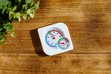 White Thermometer On Wooden Surface Showing A Temperature Of 15 Degrees Celsius