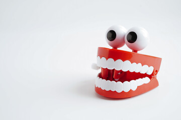 Funny red teeth with eye toy denture model for dental health care.