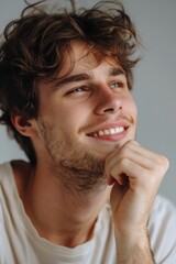 Obraz premium A person with curly hair wearing a white t-shirt, standing in a casual pose