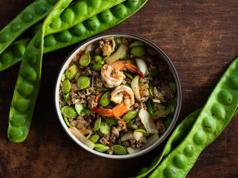 top view dish of Pad Sator, Thai stir fried stinky beans or Parkia speciosa with shrimp and minced pork