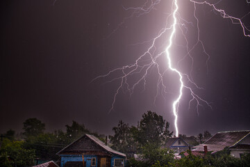 Electrical discharge of lightning in a thunderstorm. Dark background. A large number of illuminated...