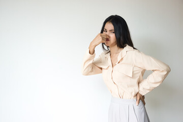 Stinking Odor and Disgusted Expression, Asian Woman Reacting to Unpleasant Smell Concept Image