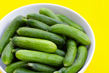 Mini cucumbers in white bowl