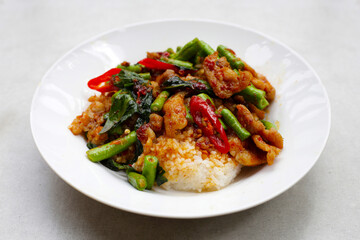 Rice topped with stir fried pork and red curry paste with yard-long bean