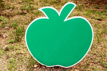 A sign in the shape of an apple