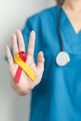 World hepatitis day awareness month, 28 July. Doctor holding Red and Yellow ribbon. Liver cancer, Jaundice, Cirrhosis, Failure, Enlarged, Hepatic Encephalopathy and Health concept