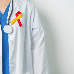 World hepatitis day awareness month, 28 July. Doctor holding Red and Yellow ribbon. Liver cancer,...