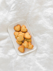 Crispy sugar butter cookies heart on a plate on a light background, top view