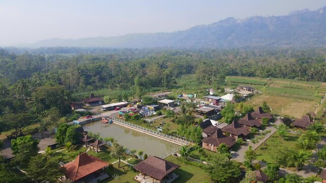 Aerial view of "Balkondes Wanurejo" and Junkyard Pank in sunny morning and hills on the background. Borobudur, Indonesia