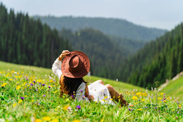 Young woman traveler relaxing and enjoying beautiful Scenery landscape with colorful flowers in...