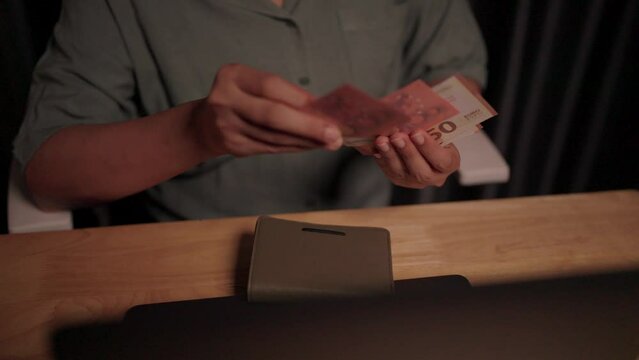 Working woman counting money from wallet, financial problems, savings planning, finances, poverty during the economic crisis, not enough money, economic downturn, basic needs