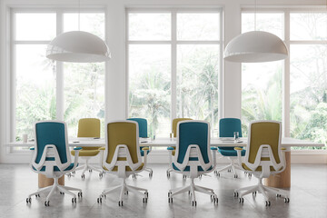 Modern conference room with colorful chairs around a table, set against large windows showing tropical foliage, bright interior. Concept of an office space.  3D Rendering