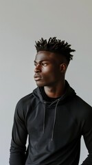Obraz premium A male model in a black hoodie looks off to the side