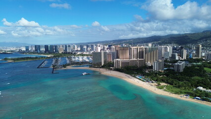 Aerial View of Honolulu's Skyline and Beachfront with Mountains in the Background