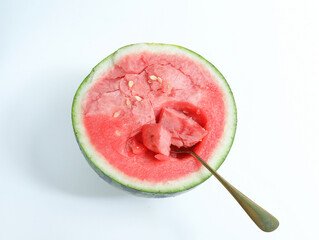 Watermelon, a fresh summer fruit, is cut open on a white table