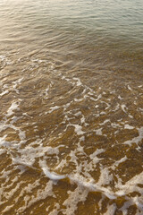 Sea waves sand  at sunrise.