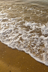 Sea waves sand  at sunrise.