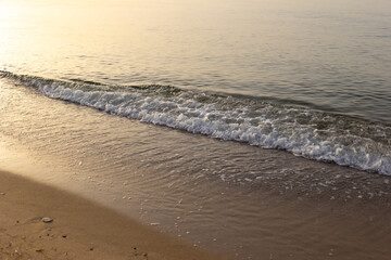 Sea waves sand  at sunrise.