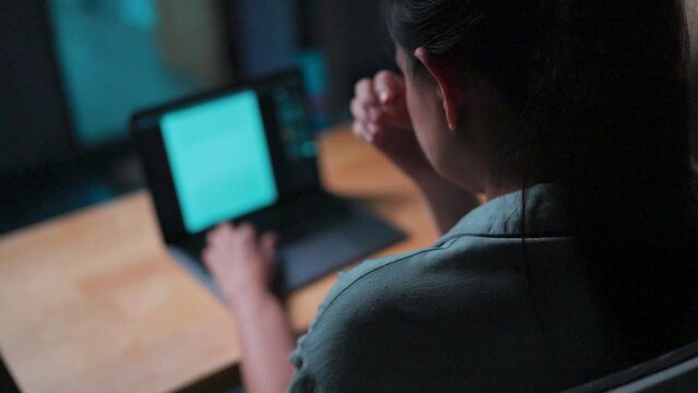 Stressed woman working with computer laptop, she is seriously working, is stressed and tired from failed tasks, stiff neck relief pain ache sit on desk table computer ,office syndrome impact at home.