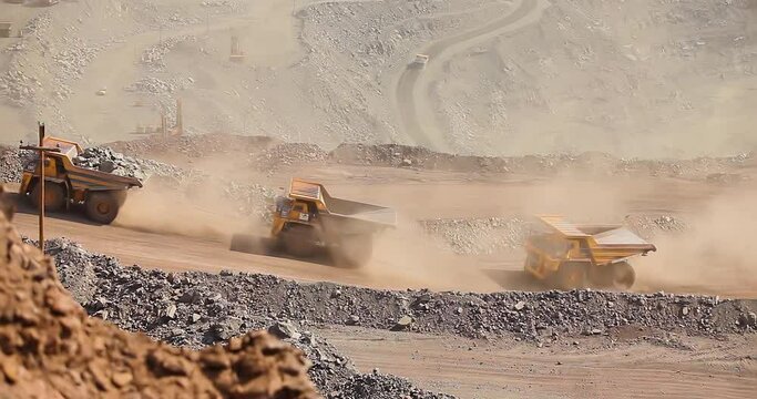 Quarry truck driving on the road in deep quarry. A large mining truck transports ore. Dumper.