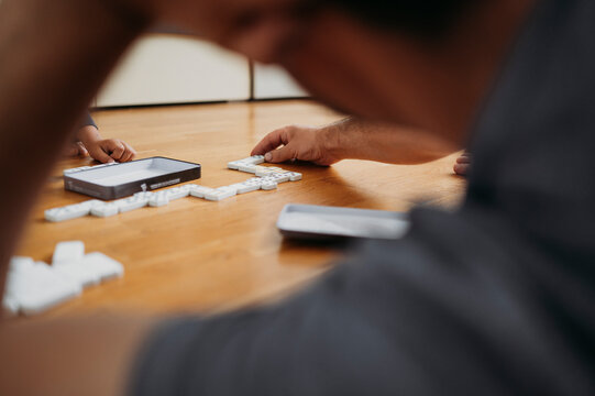 Father and son playing dominoes at home