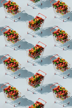 Seamless pattern of shopping cart filled with colorful fruits and vegetables against blue background