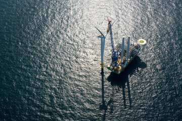 Aerial view of wind turbine installation vessel at offshore wind farm in North Sea on sunny day