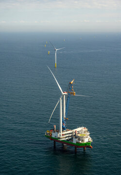 Aerial view of wind turbine installation vessel at offshore wind farm in North Sea under sky